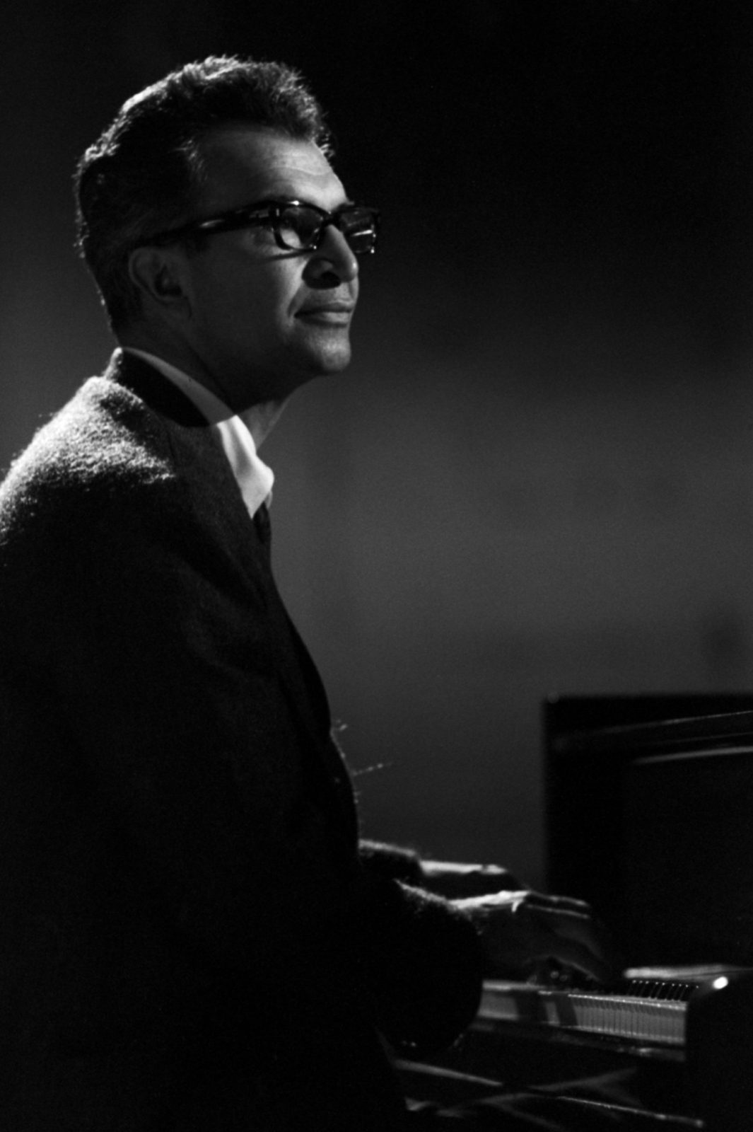 A side profile shot of Dave Brubeck at the piano looking upwards