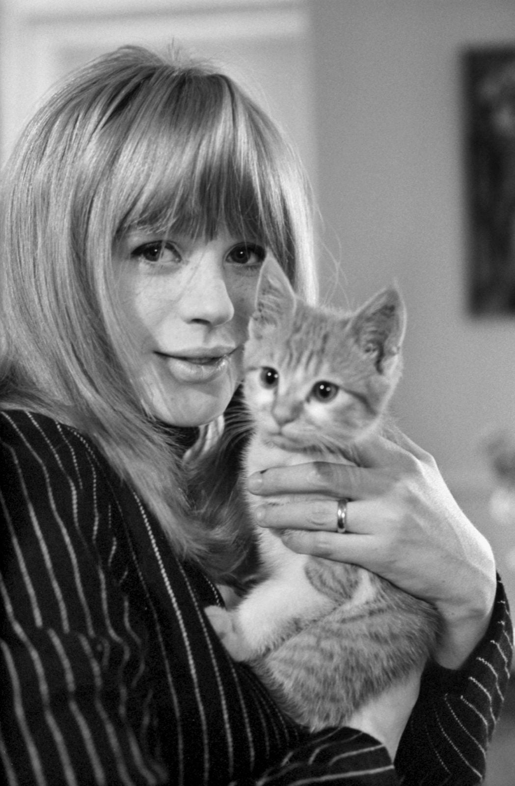A lady named Marianne and a ginger and white kitten in her arms